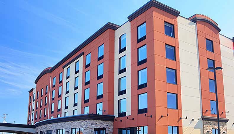 Brick-and-panel hotel with punched aluminum windows