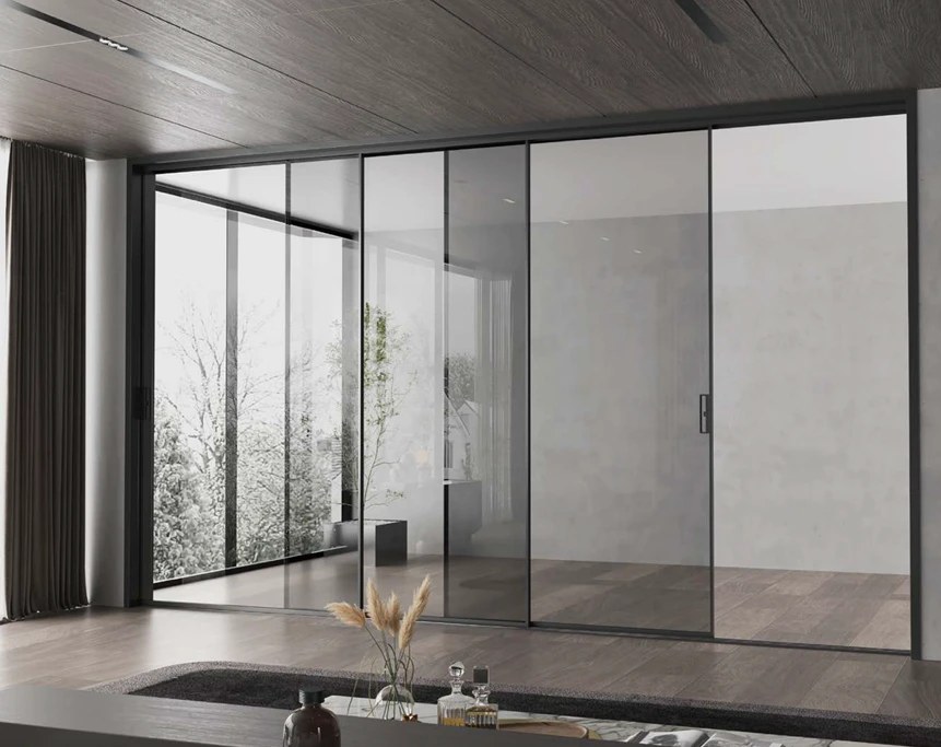 Black aluminum sliding glass wall dividing an open interior