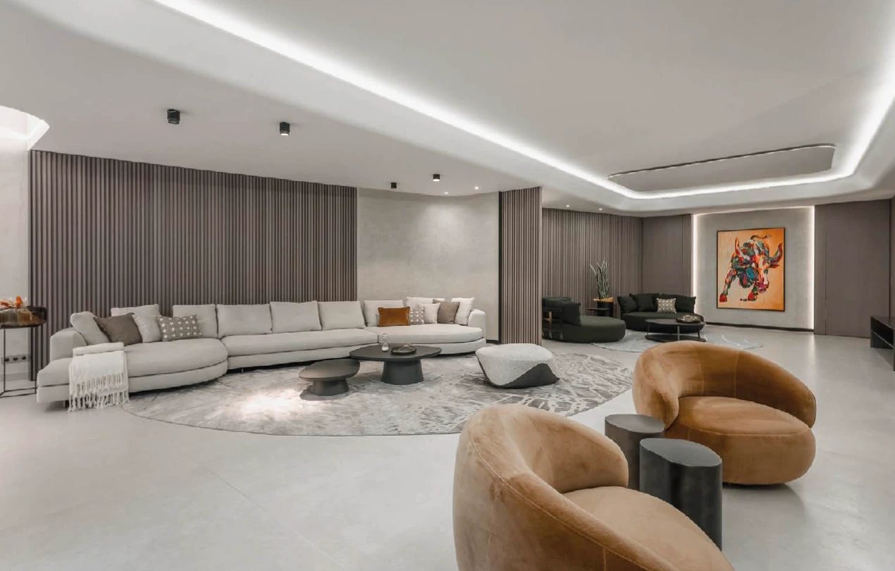 Lounge with slatted wall panels and a cove-lit ceiling