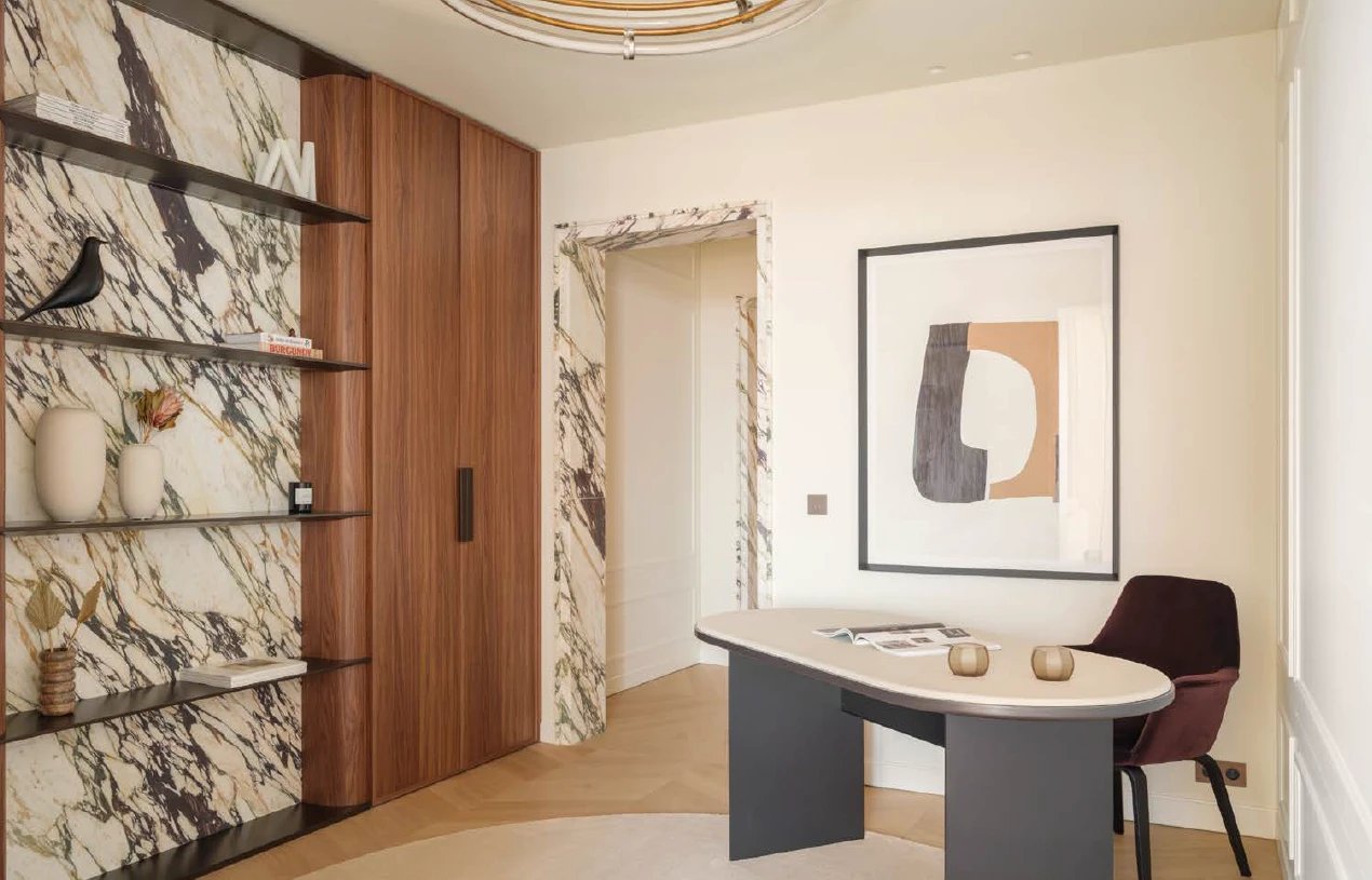 Study with a marble-framed doorway and walnut wall