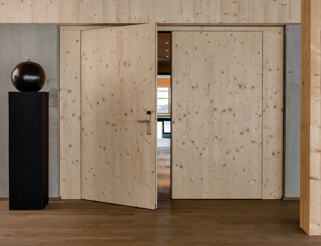 Spruce double door set flush into a timber wall