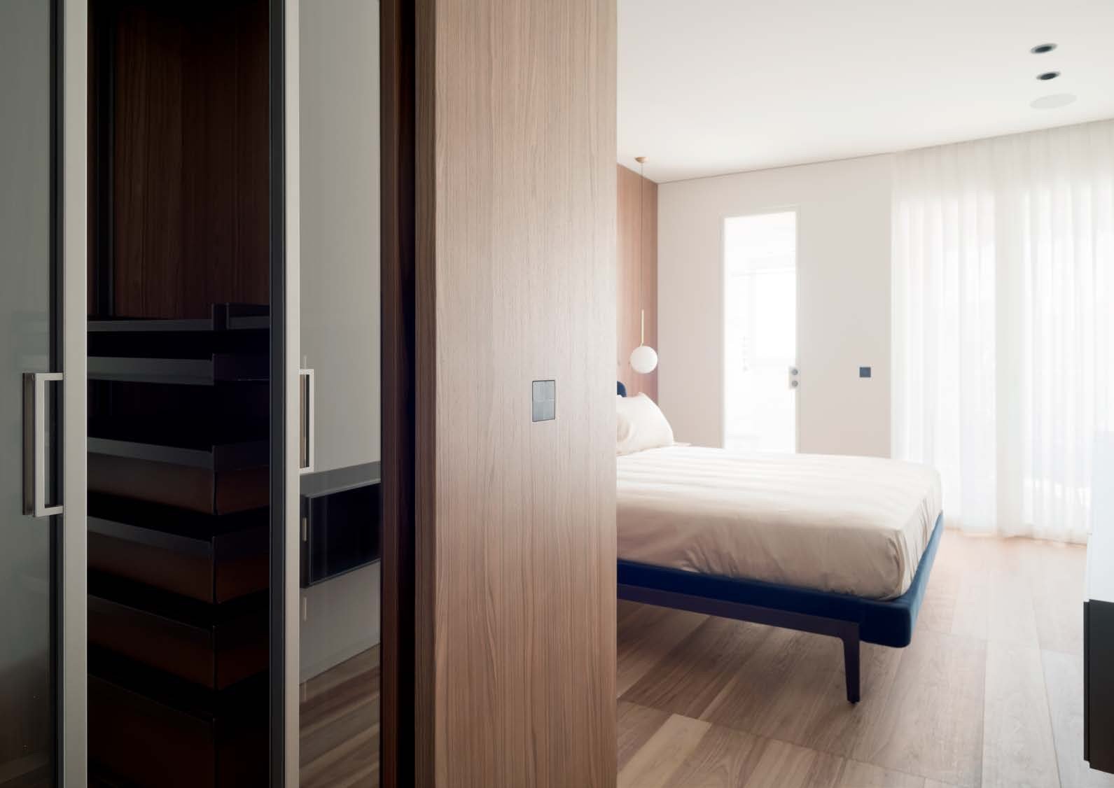 Bedroom suite behind a sliding glass wall