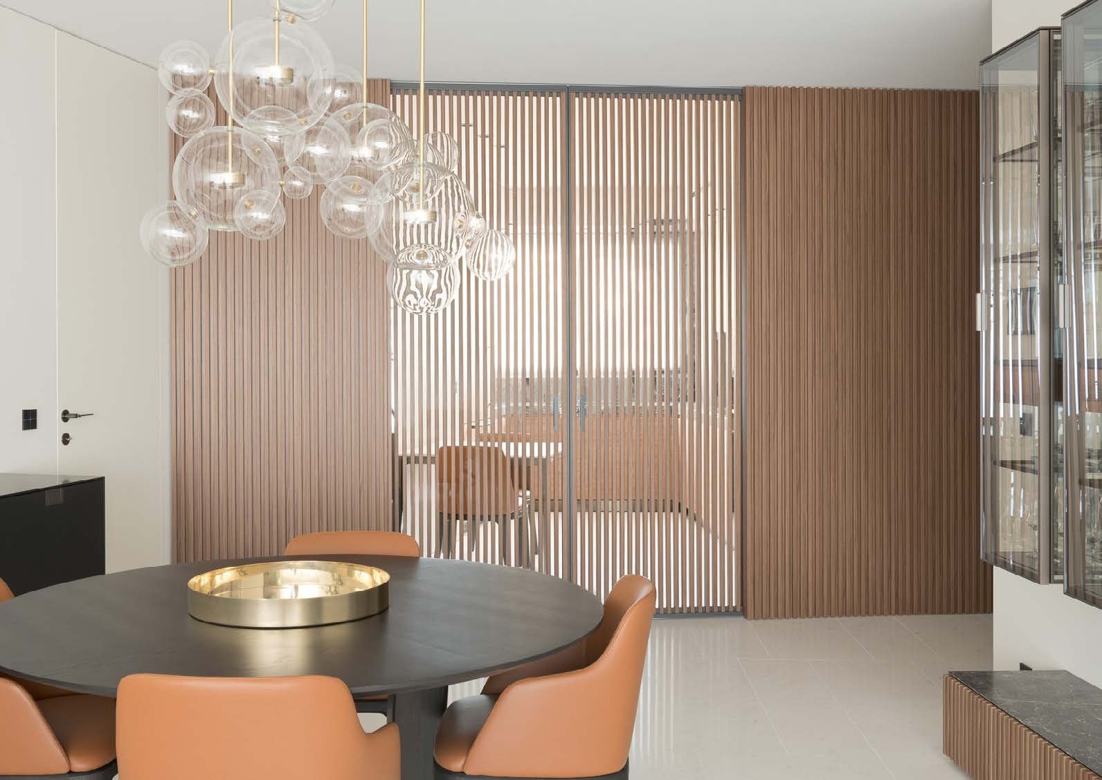 Dining room behind slatted wood and glass screens