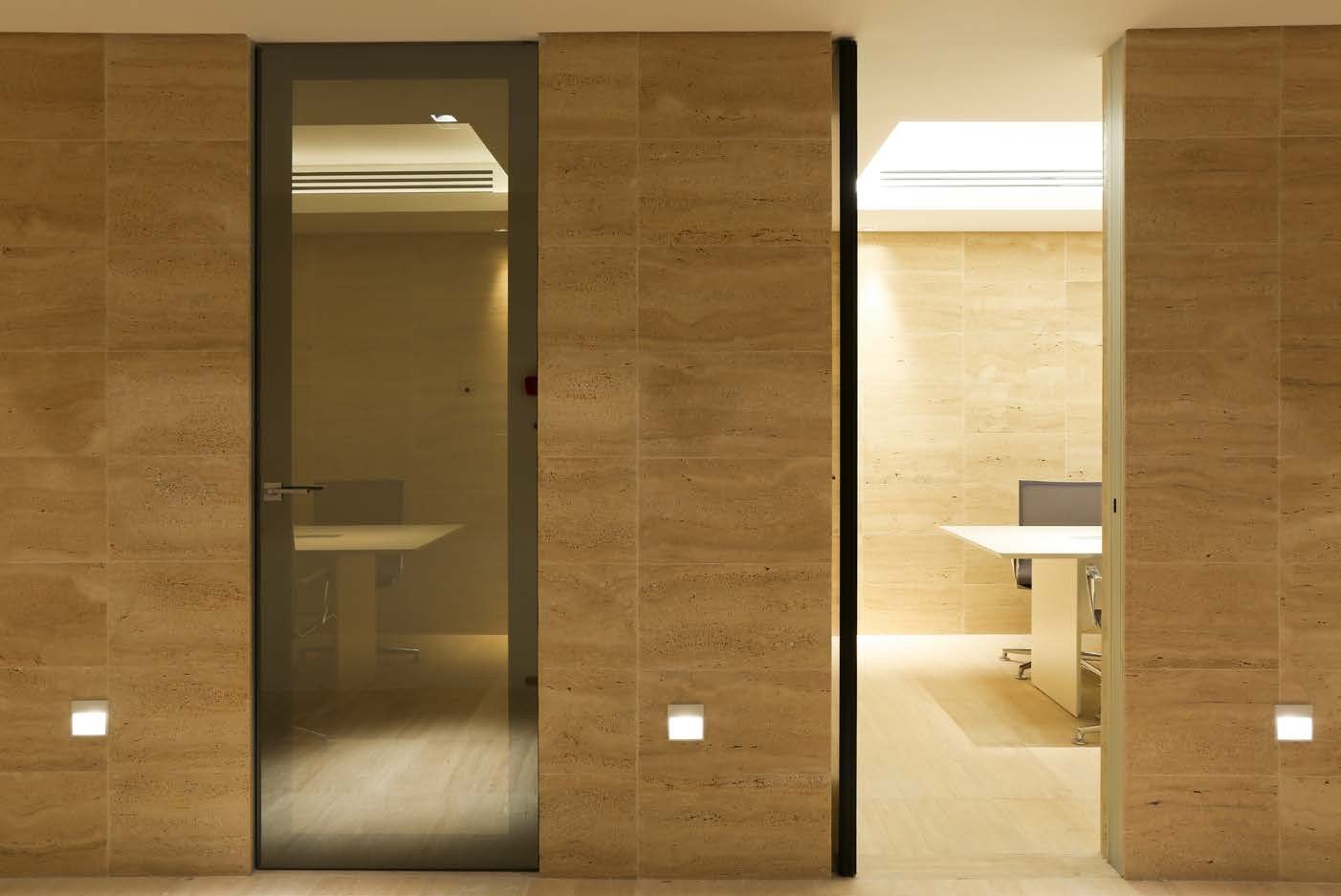 Glass door set into a travertine wall