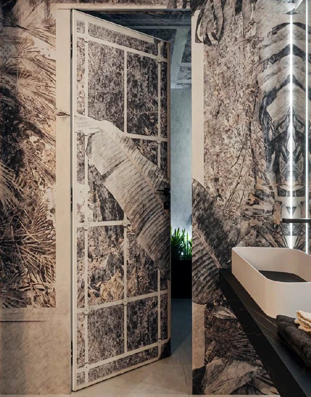 Concealed door clad in botanical wallcovering