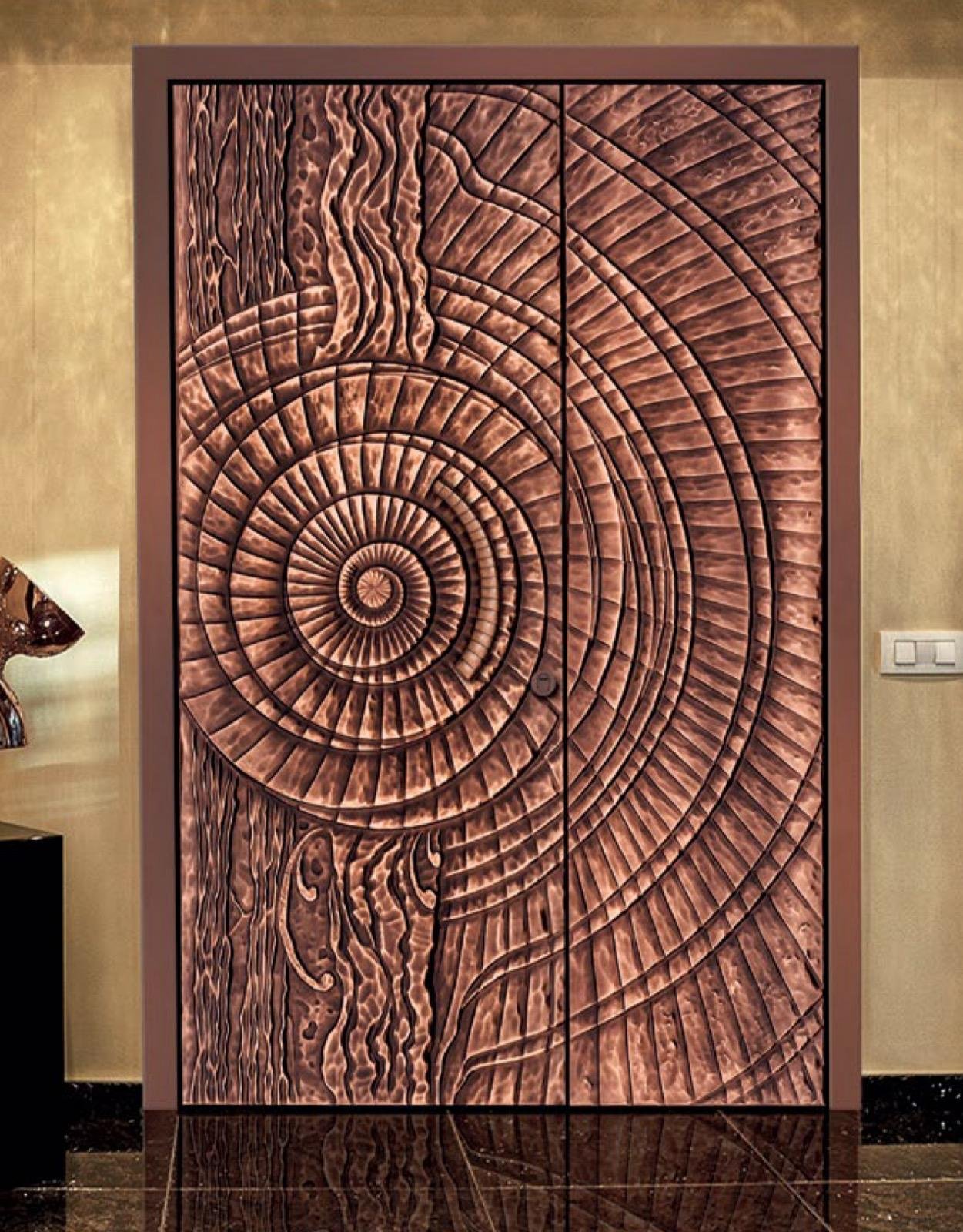 Copper double door hand-worked in a radiating ring relief