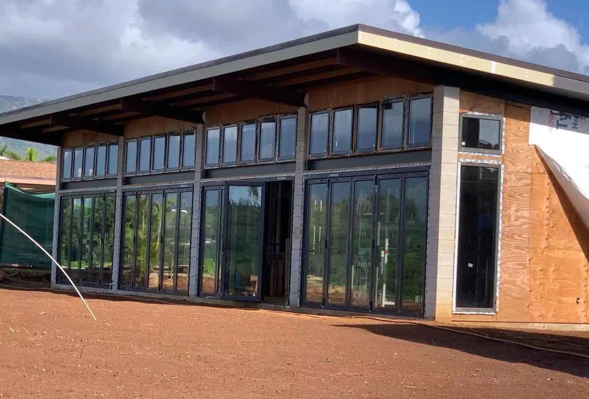Black impact bifold doors and clerestory windows on a new island home