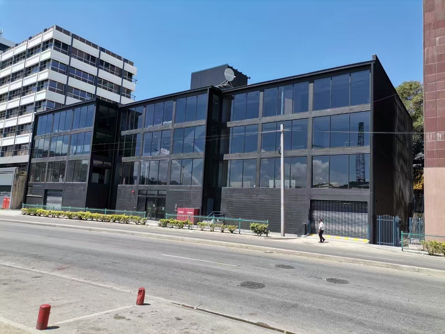 Three-storey black window wall office building on a city street
