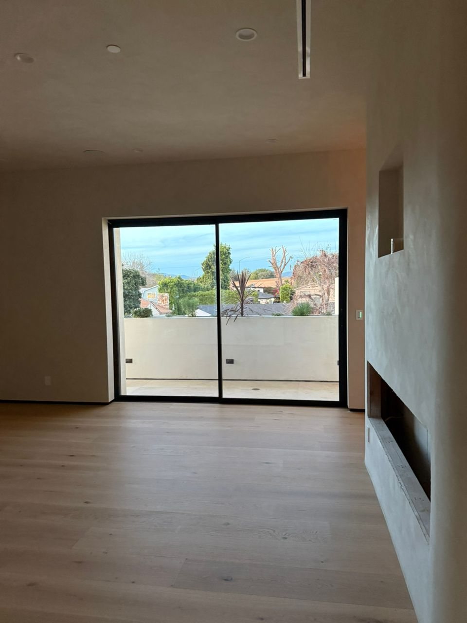 Slim black sliding door opening a bedroom to the terrace