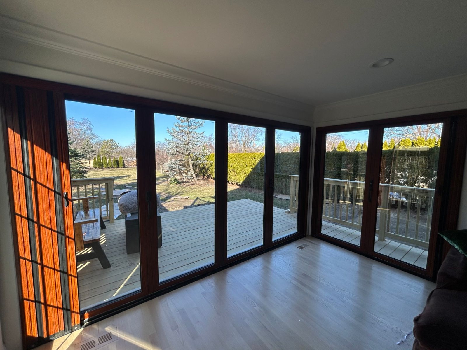 Woodgrain corner bifold doors seen from inside the family room