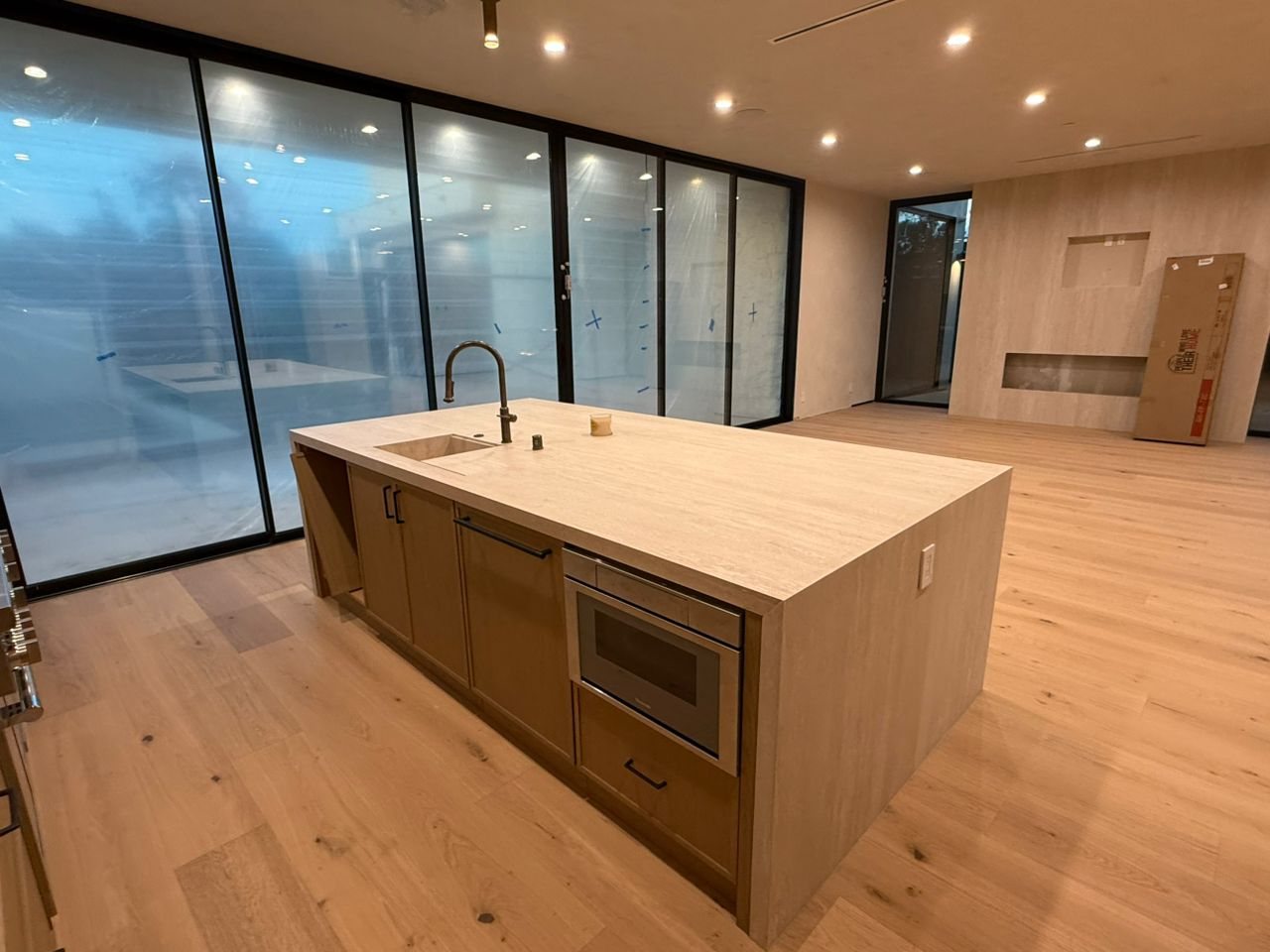 Six-panel black sliding glass wall behind a kitchen island