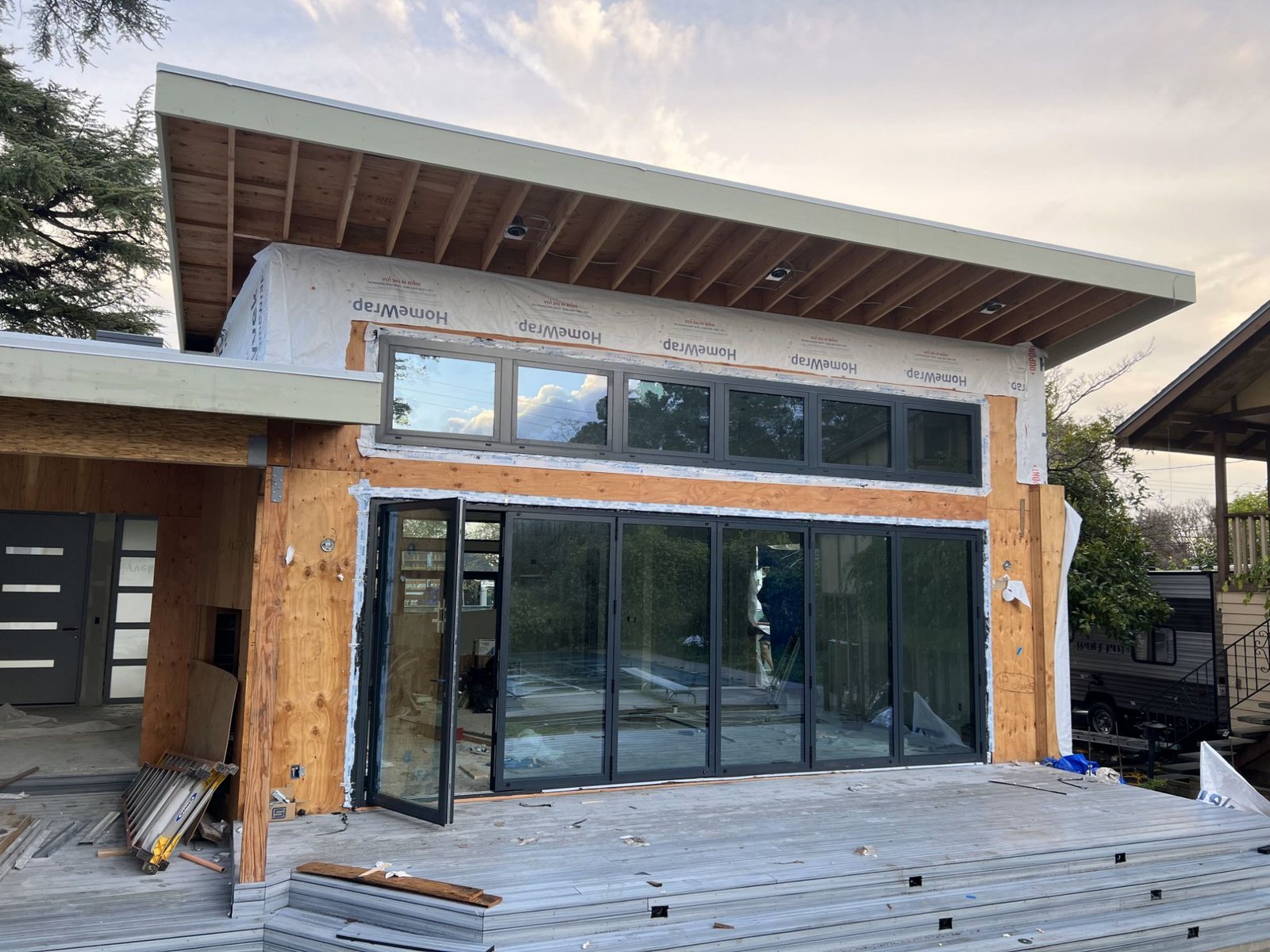 Six-panel black bifold door and clerestory windows on a modern addition