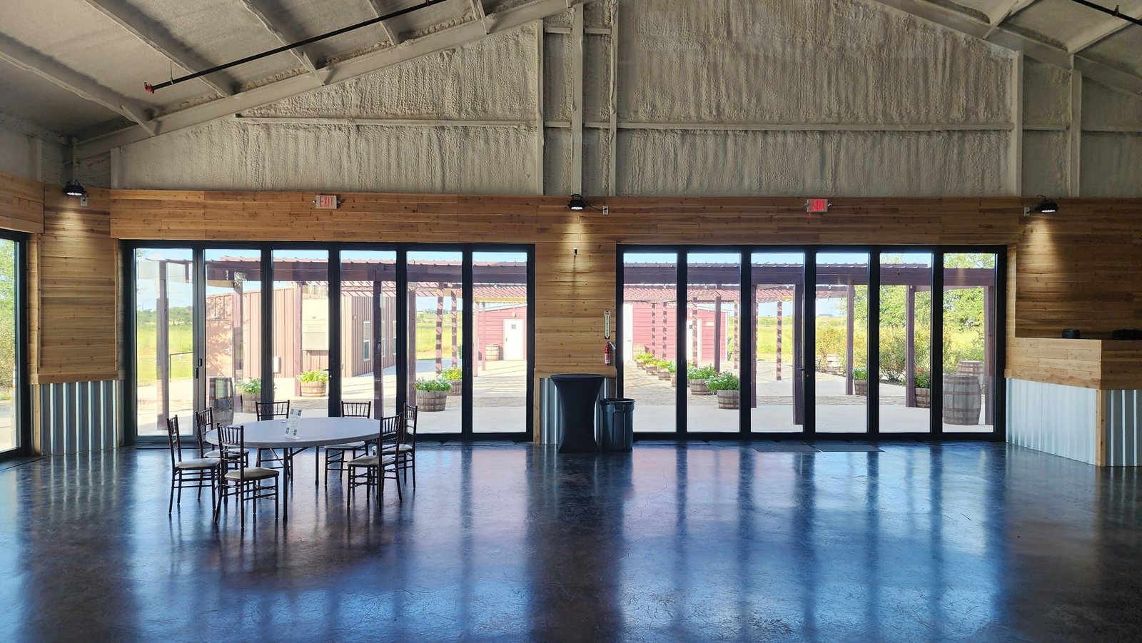 Event barn lined with two black bifold door walls