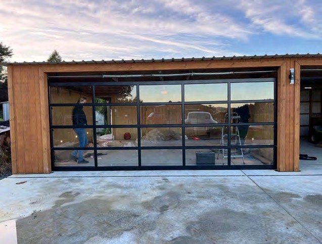 Black full-view glass garage door on a cedar garage