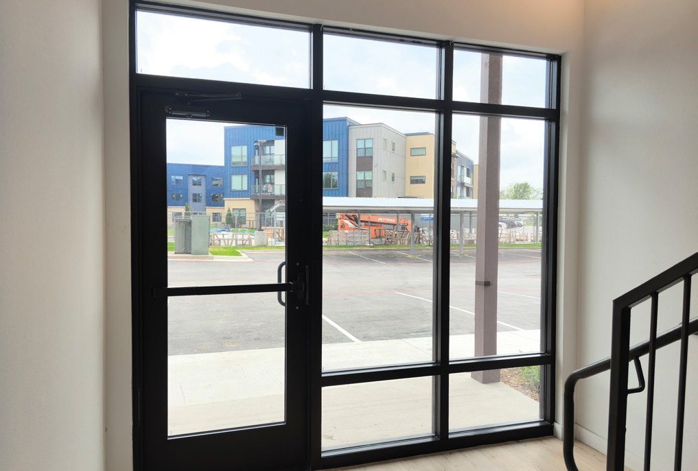 Storefront entrance door with sidelites and transoms, seen from inside