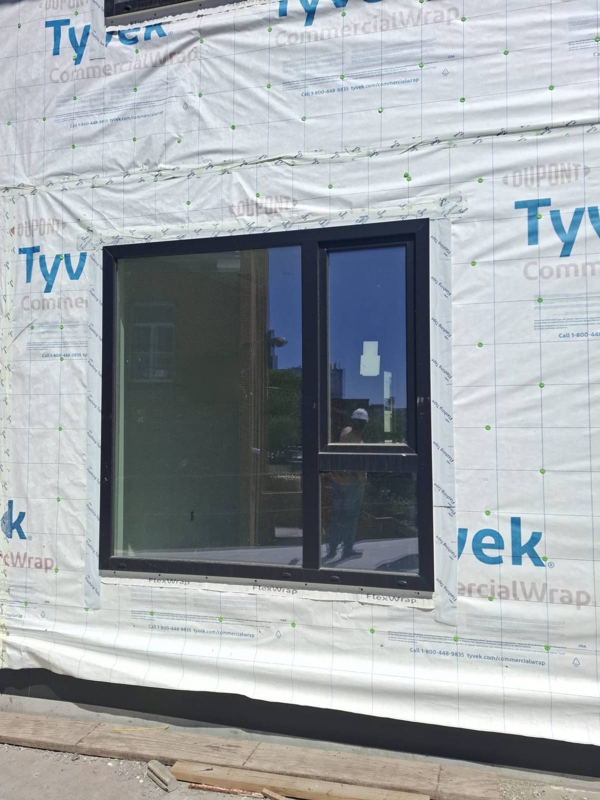 Black window with an operable lite installed and flashed in the air barrier