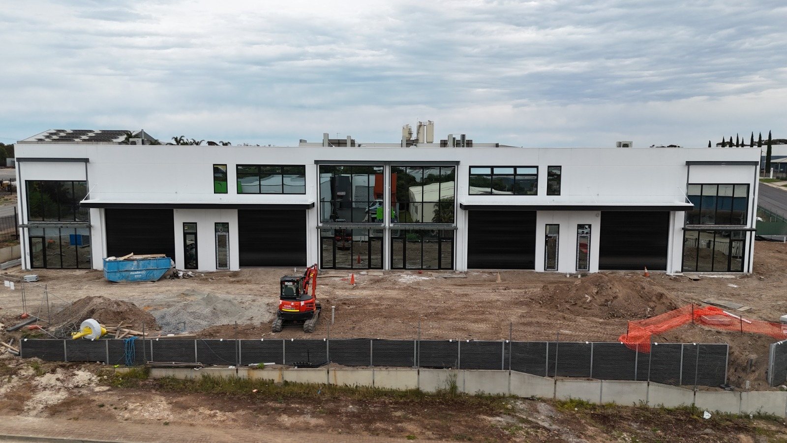 Storefront and window wall across a row of new commercial units