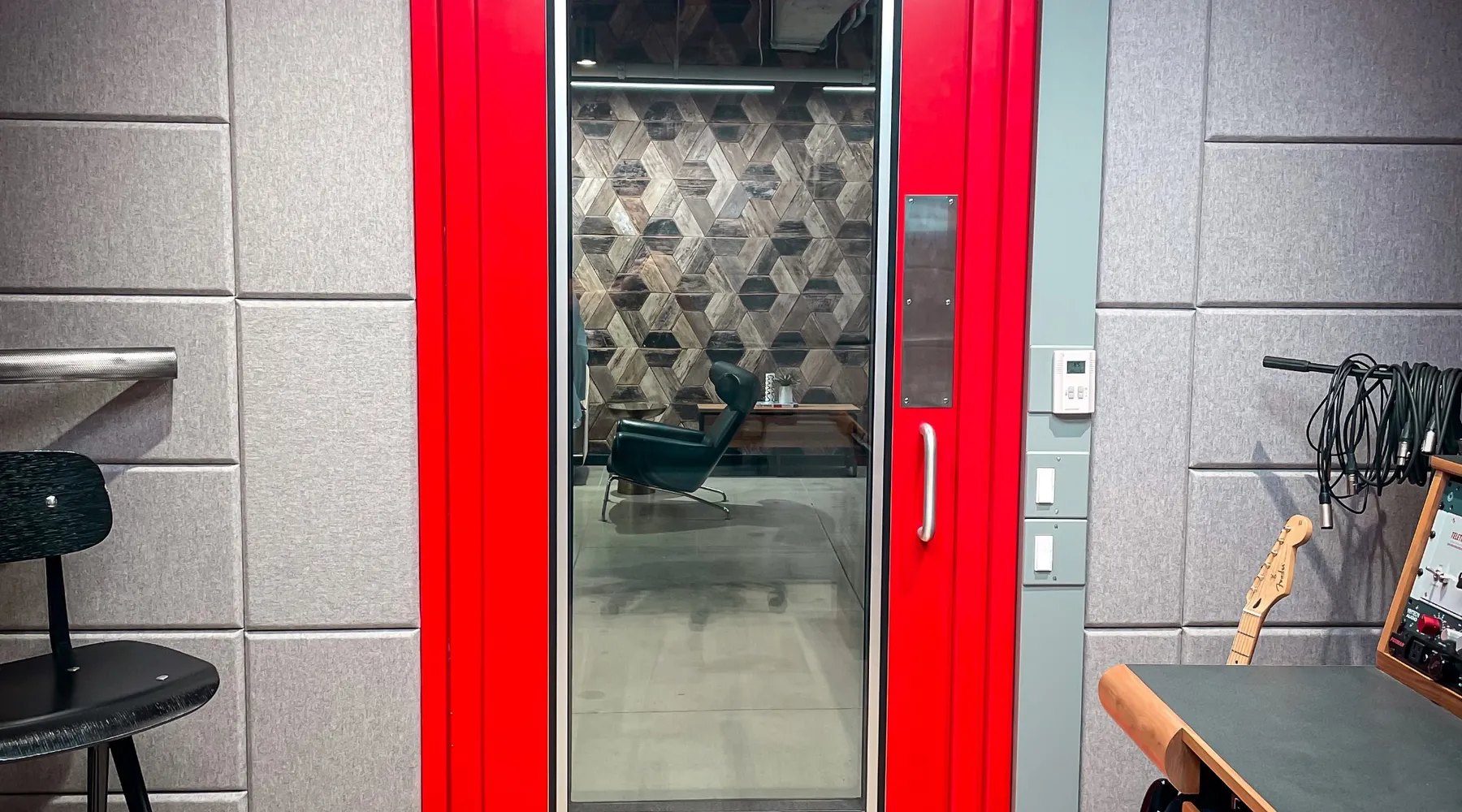 Red acoustic door in a modern recording studio