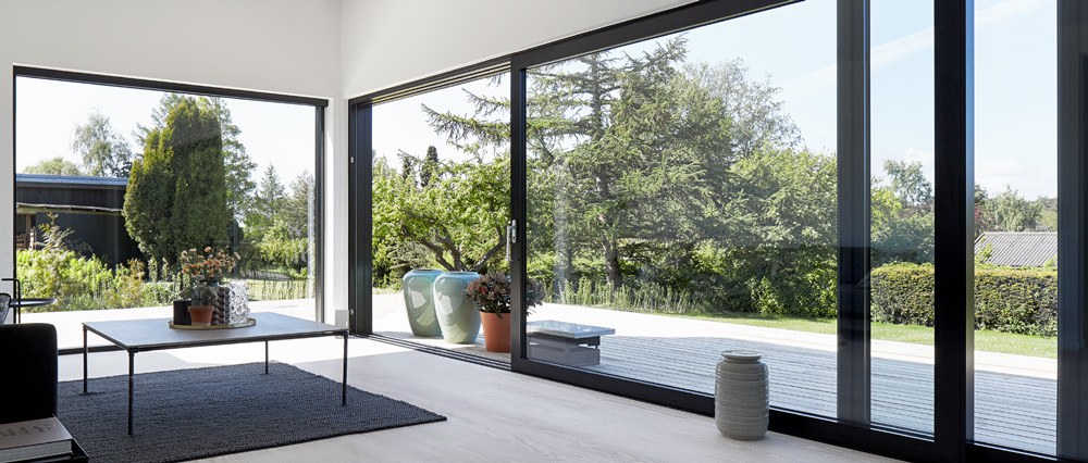 Oversized uPVC lift-and-slide doors around a corner lounge