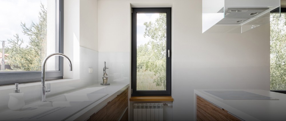 Black uPVC tilt-and-turn window beside a white kitchen