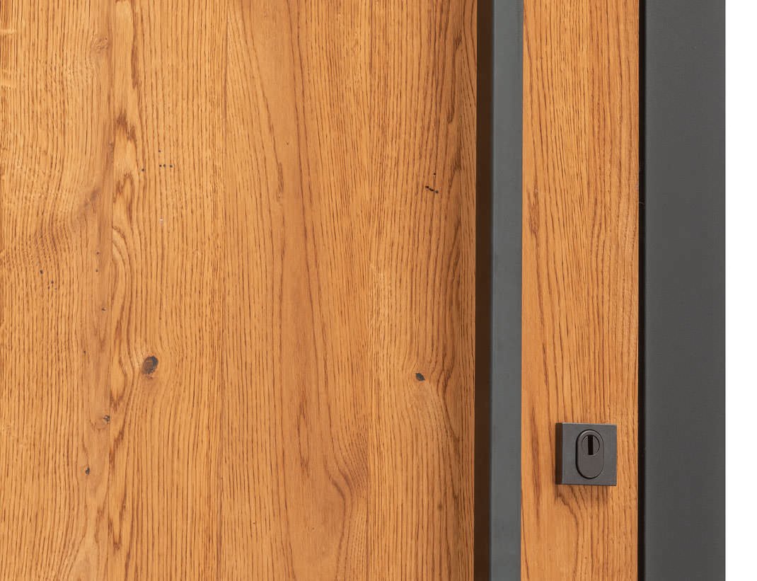 Oak-clad entry door with a slim dark frame