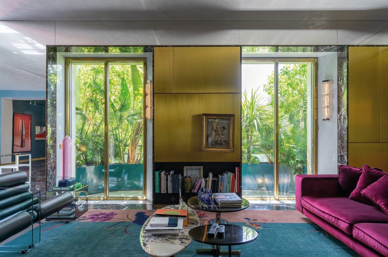 Steel-framed glass doors and brass panels in a garden living room