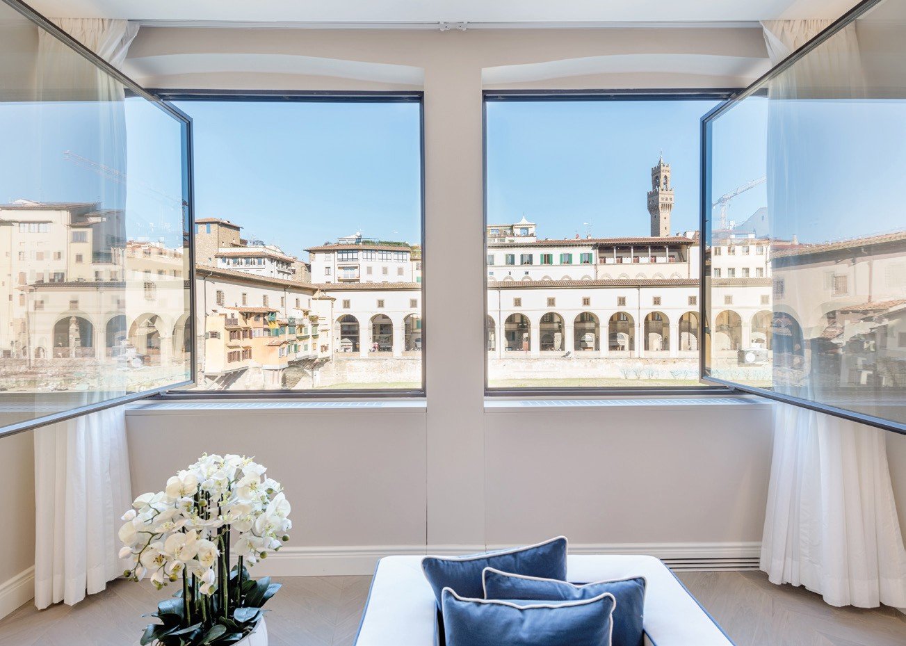 Steel casement windows framing a historic square