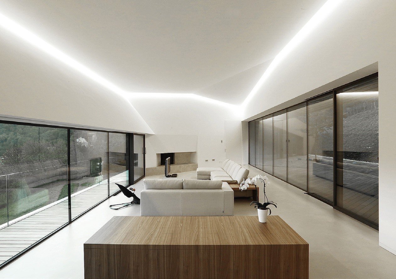 Minimal sliding glass wall along a long gallery