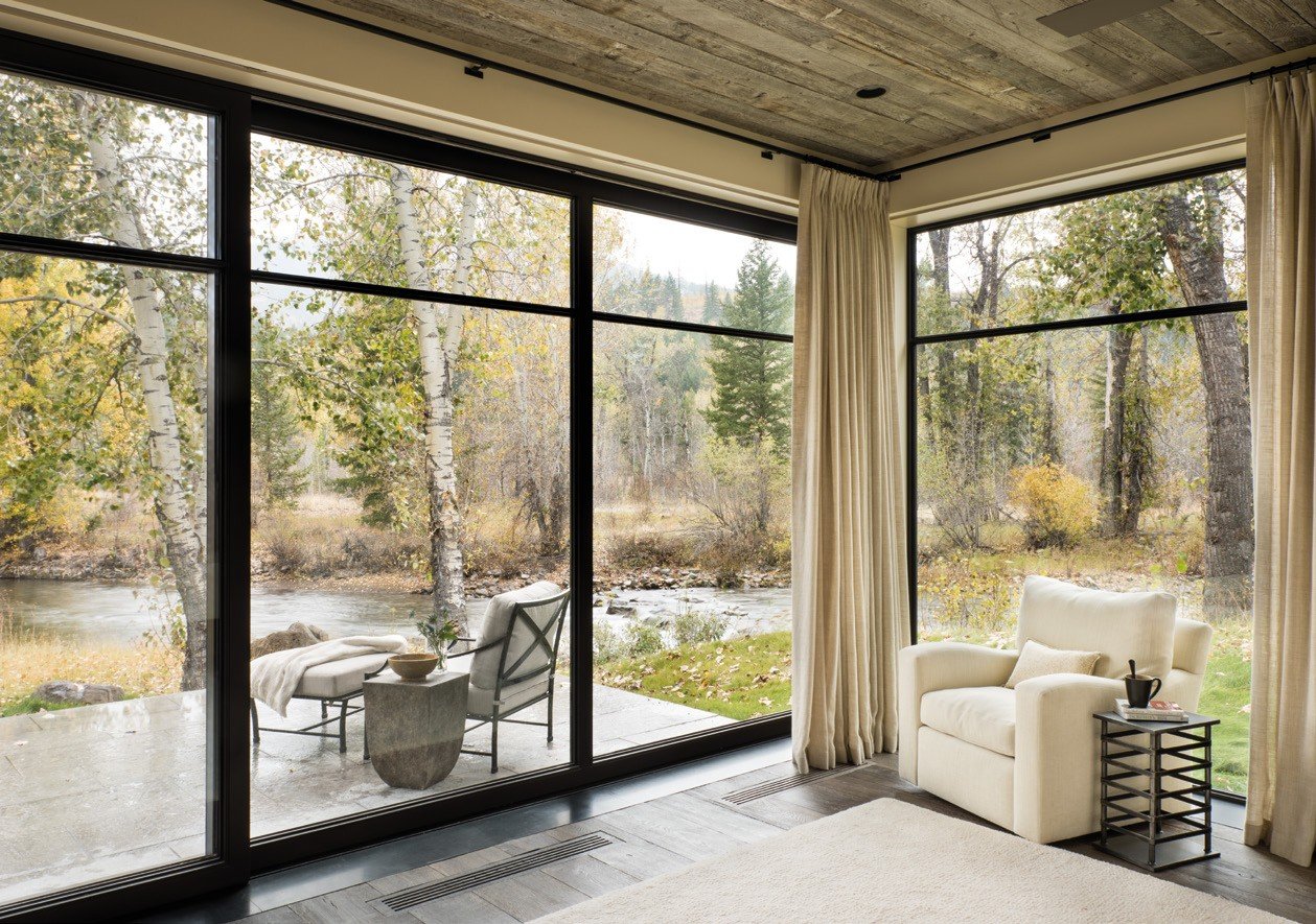 Corner steel window wall overlooking a river