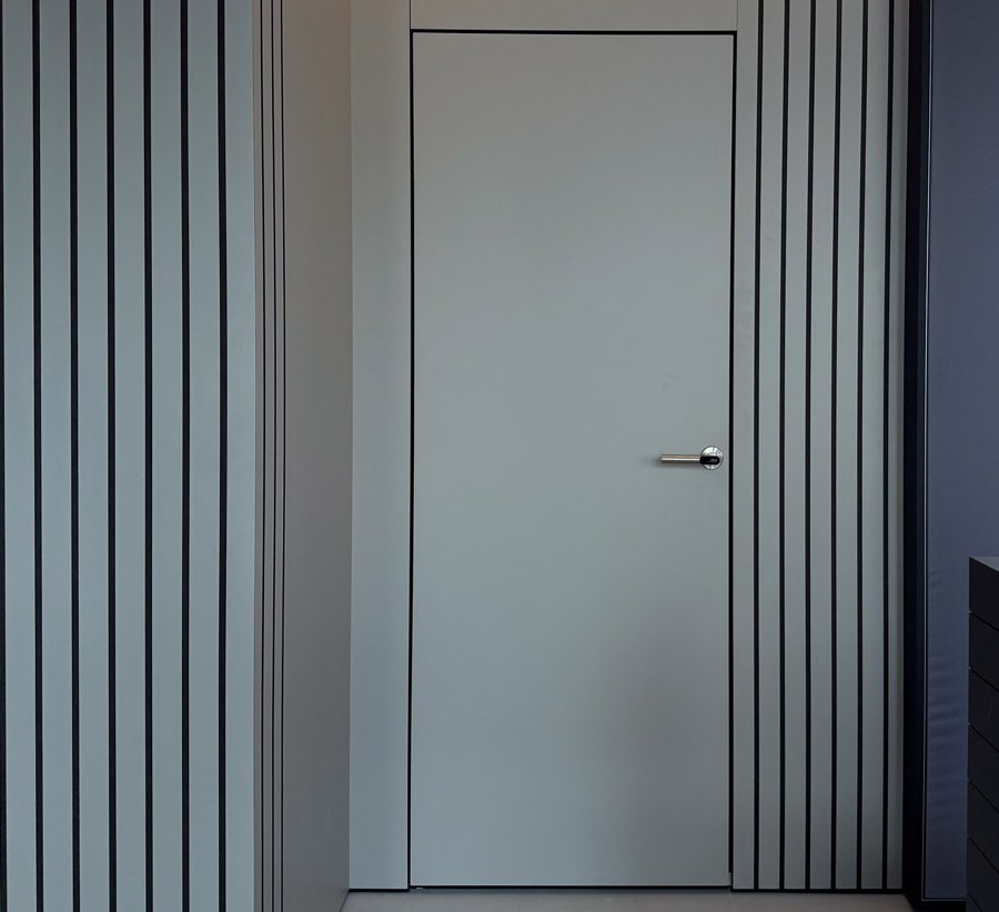 Flush grey door between striped wall panels