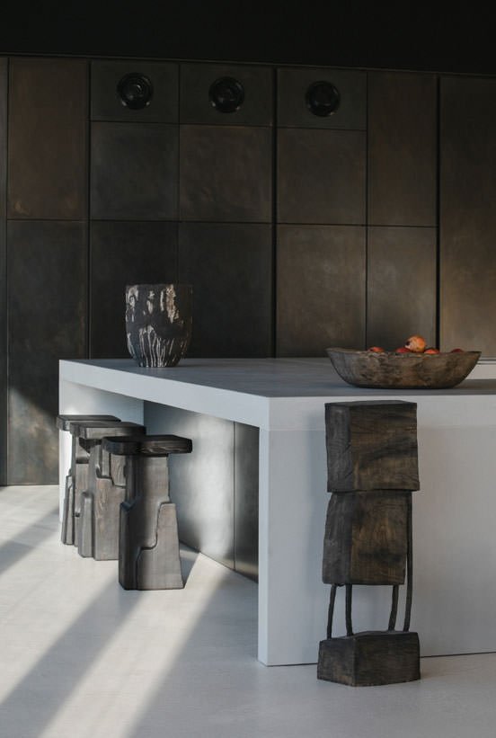 Blackened-steel kitchen wall and concrete island